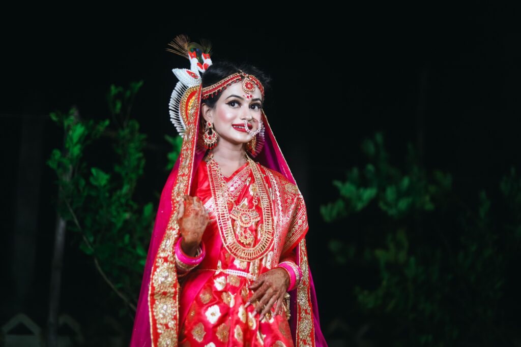 A stunning portrait of a woman in traditional bridal attire, showcasing intricate jewelry and cultural elegance.